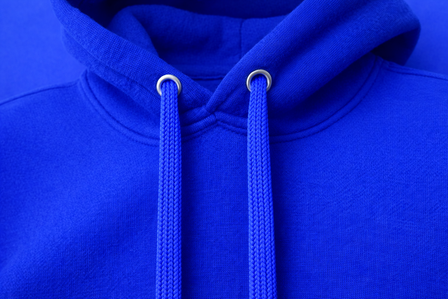 Close-up of a blue hoodie with drawstrings against a blue background